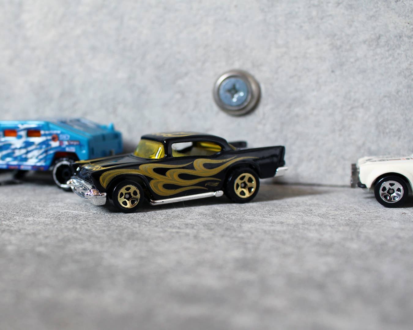 A Hot Wheels hot rod with flames parallel parking.