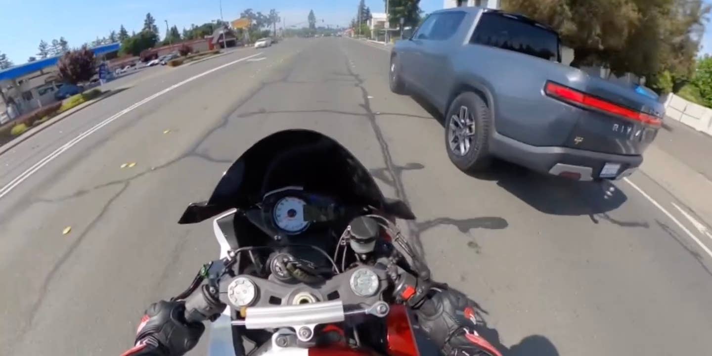 Helmet camera footage from a Kawasaki motorcycle rider as they try to distance themselves from an aggressively driving grey Rivian R1T