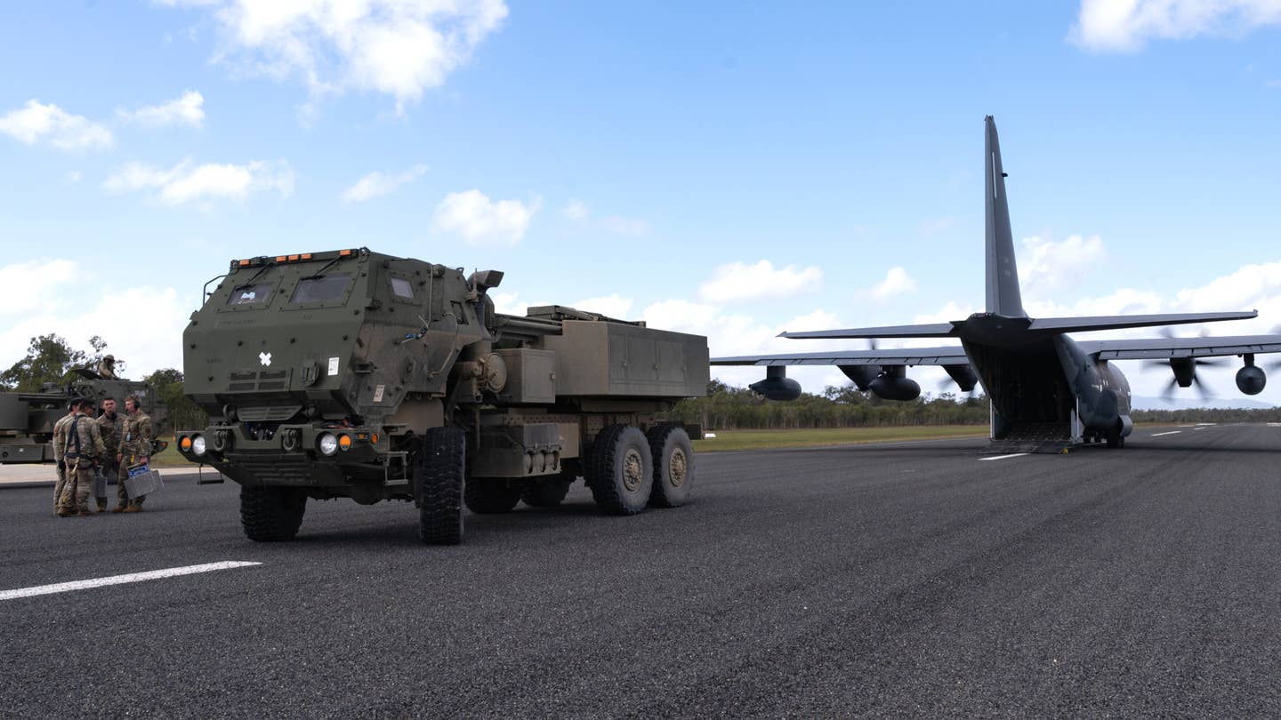 US Army M142 High Mobility Artillery Rocket System (HIMARS) launchers, at left, which are capable of firing Army Tactical Missile System (ATACMS) missiles participating in Talisman Sabre 23. A US Air Force MC-130J Commando II special operations tanker/transport aircraft is seen at right. <em>USAF</em>